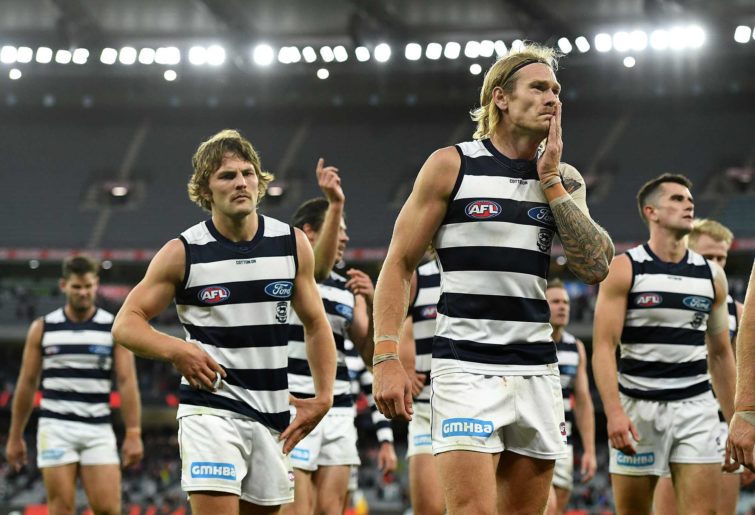 Tom Stewart and his Cats teammates look dejected