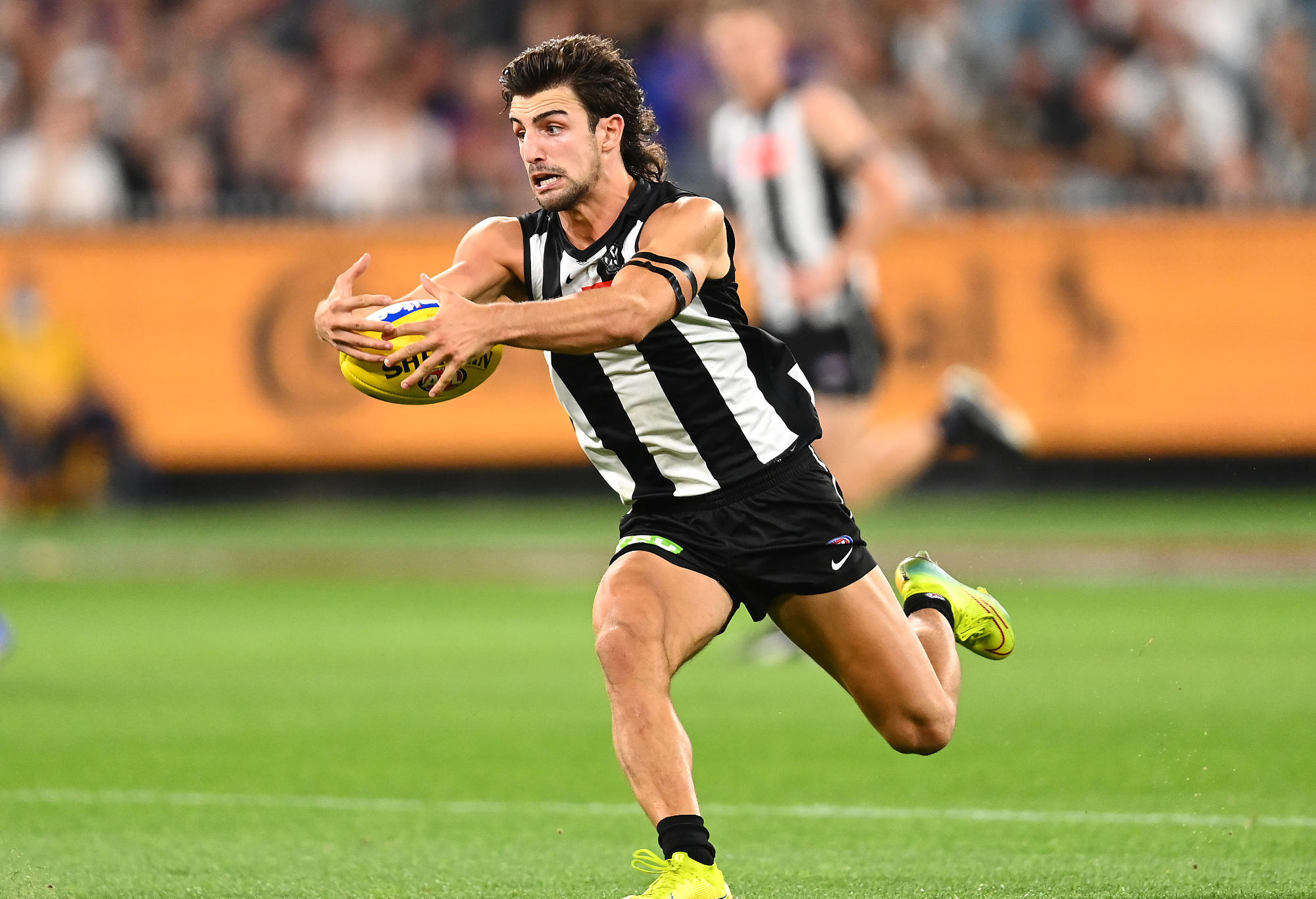 Josh Daicos of the Magpies gathers the ball