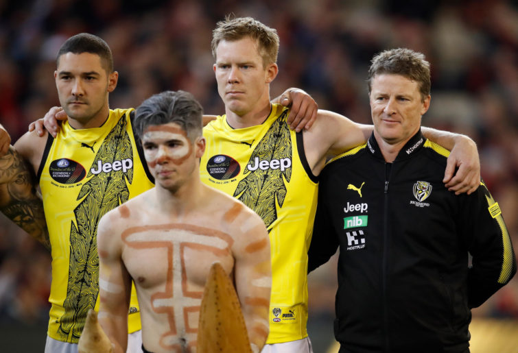 Shaun Grigg, Jack Riewoldt and Damien Hardwick of the Tigers look on during the war cry during Dreamtime at the G.