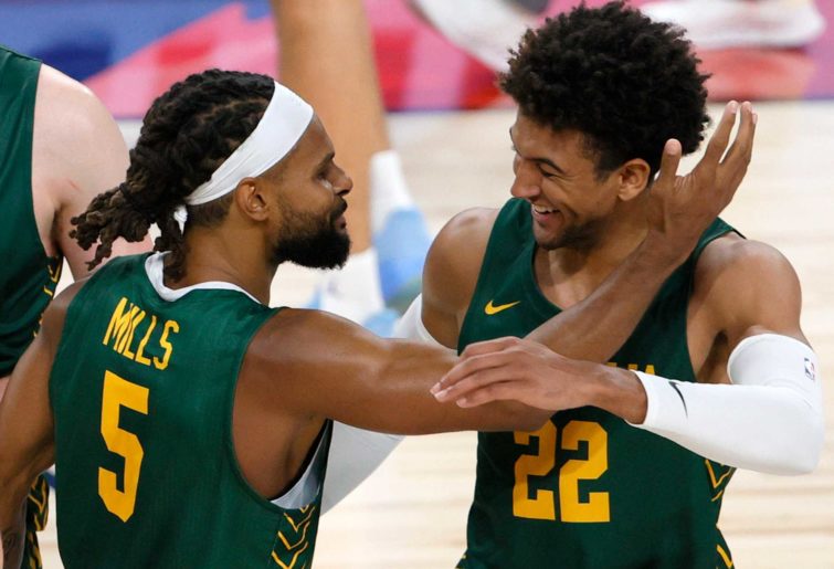 Patty Mills #5 of the Australia Boomers celebrates with teammate Matisse Thybulle #22