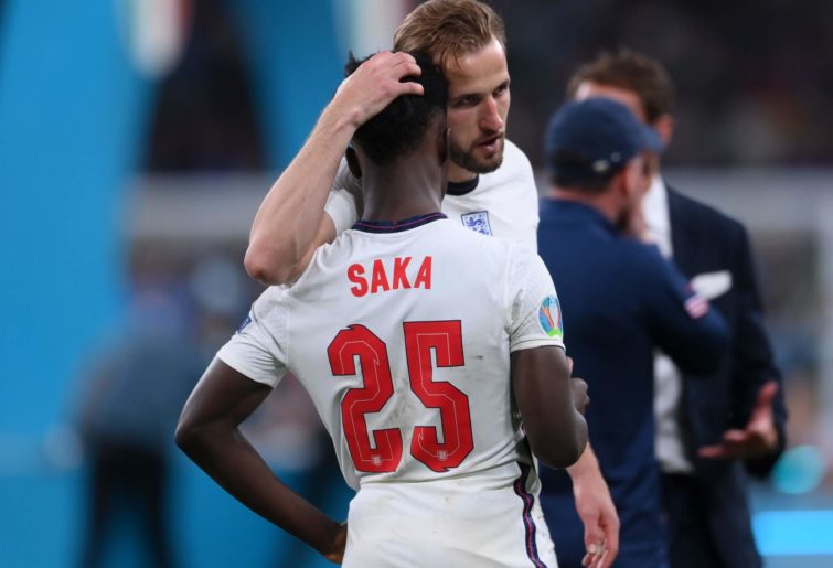 Bukayo Saka of England is consoled by teammate Harry Kane