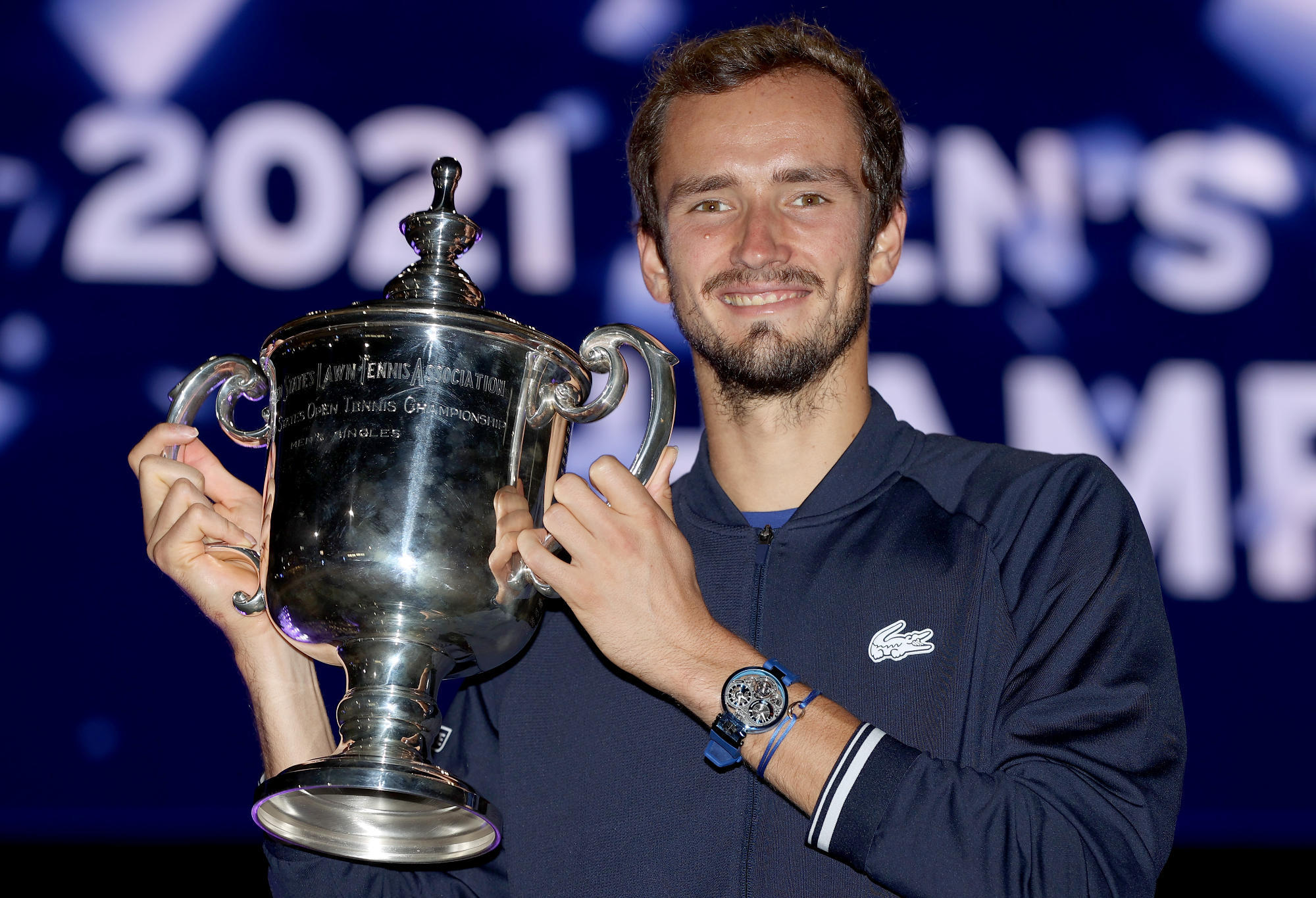 Daniil Medvedev of Russia celebrates with the championship trophy
