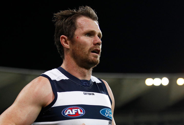 Patrick Dangerfield of the Cats looks on with blood on his face