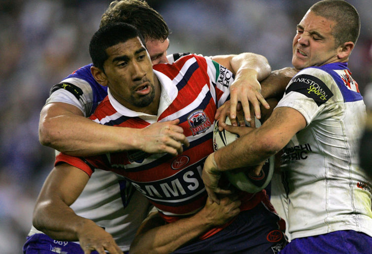 Sia Soliola fights off a tackle against the Bulldogs