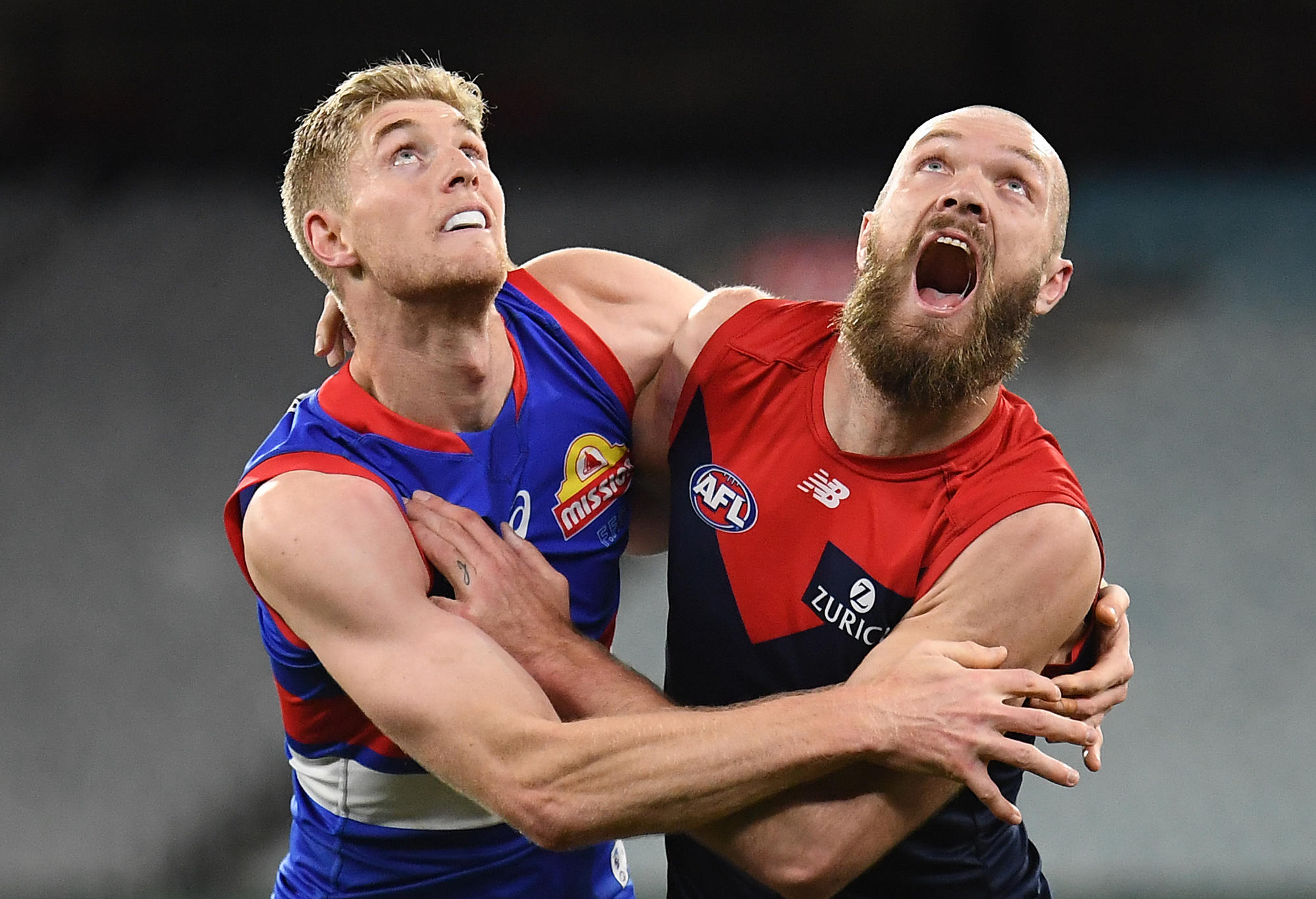 Tim English of the Bulldogs and Max Gawn of the Demons compete for the bal;