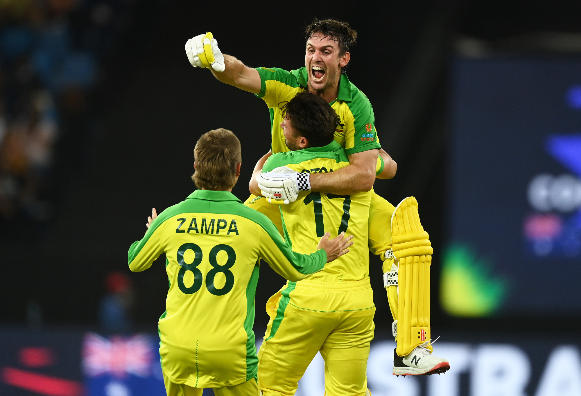 Mitchell Marsh celebrates with Adam Zampa and Marcus Stoinis.