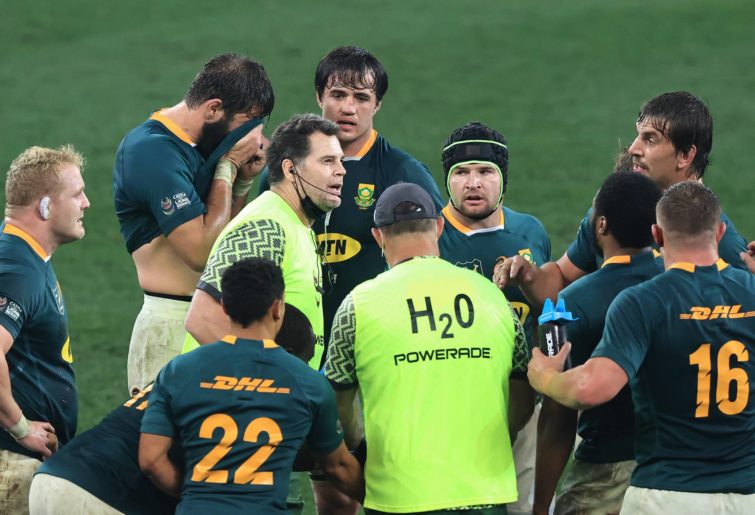 : Rassie Erasmus, the Springboks director of rugby acting as a water carrier talks to his team during the 2nd test match between South Africa Springboks and the British & Irish Lions at Cape Town Stadium on July 31, 2021 in Cape Town, South Africa. (Photo by David Rogers/Getty Images