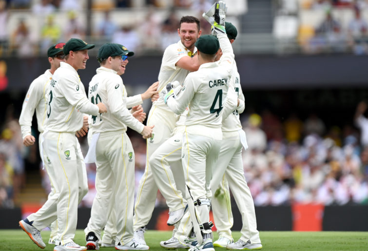 Josh Hazlewood of Australia celebrates taking the wicket of Joe Root of England during day one of the First Test Match in the Ashes series between Australia and England at The Gabba on December 08, 2021 in Brisbane, Australia. (Photo by Bradley Kanaris/Getty Images)