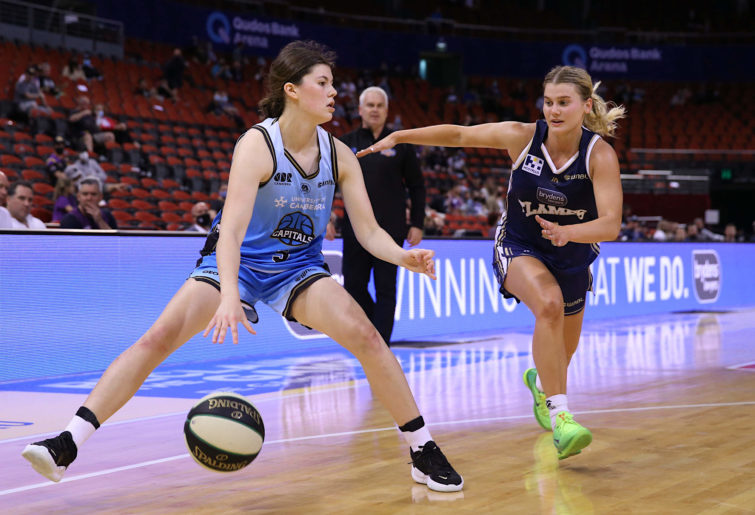 Jade Melbourne of the Capitals dribbles the ball under pressure from Shyla Heal