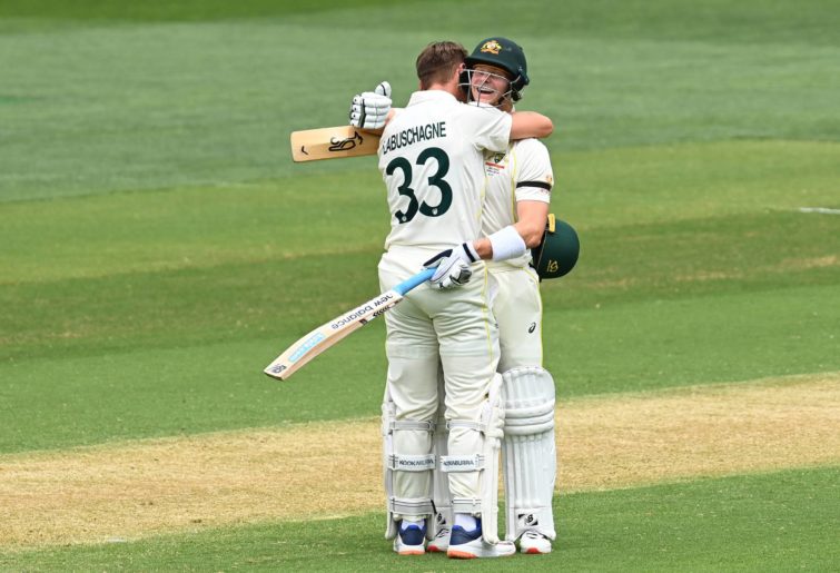Marnus Labuschagne of Australia is congratulated by Steve Smith of Australia after scoring a century during day two of the Second Test match in the Ashes series between Australia and England at the Adelaide Oval on December 17, 2021 in Adelaide, Australia. (Photo by Quinn Rooney/Getty Images)