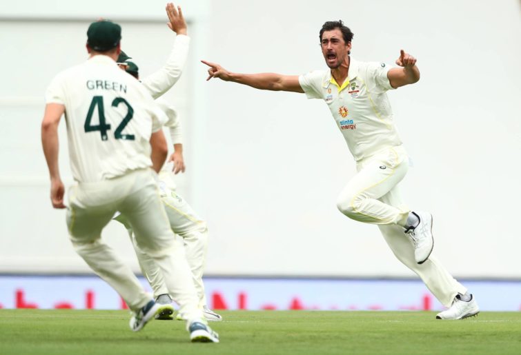Mitchell Starc of Australia celebrates dismissing Rory Burns of England during day one of the First Test Match in the Ashes series between Australia and England at The Gabba on December 08, 2021 in Brisbane, Australia. (Photo by Chris Hyde/Getty Images)