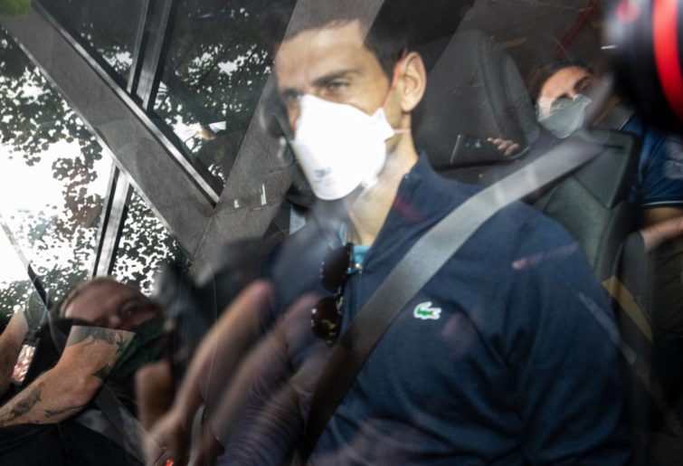 Serbian tennis player Novak Djokovic leaves the Park hotel on January 16, 2022 in Melbourne, Australia. Djokovic is in detention and faces deportation after his visa was cancelled by the Australian government. His appeal will be heard today, one day before he is scheduled to play in the Australian Open. (Photo by Diego Fedele/Getty Images)