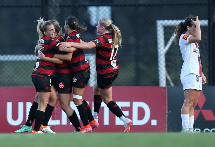 Ashlie Crofts of the Wanderers celebrates with teammates after scoring a goal.