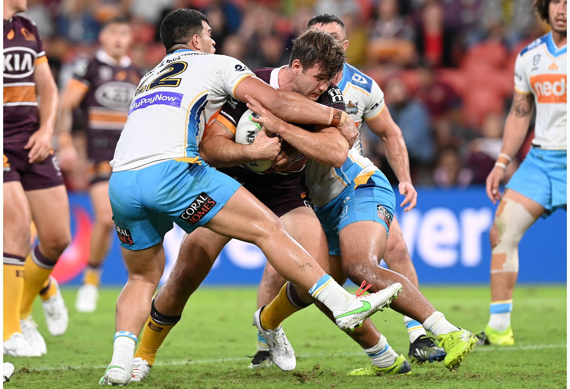 BRISBANE, AUSTRALIA - APRIL 30: Patrick Carrigan of the Broncos is tackled during the round 8 NRL match between the Brisbane Broncos and the Gold Coast Titans at Suncorp Stadium, on April 30, 2021, in Brisbane, Australia. (Photo by Bradley Kanaris/Getty Images)