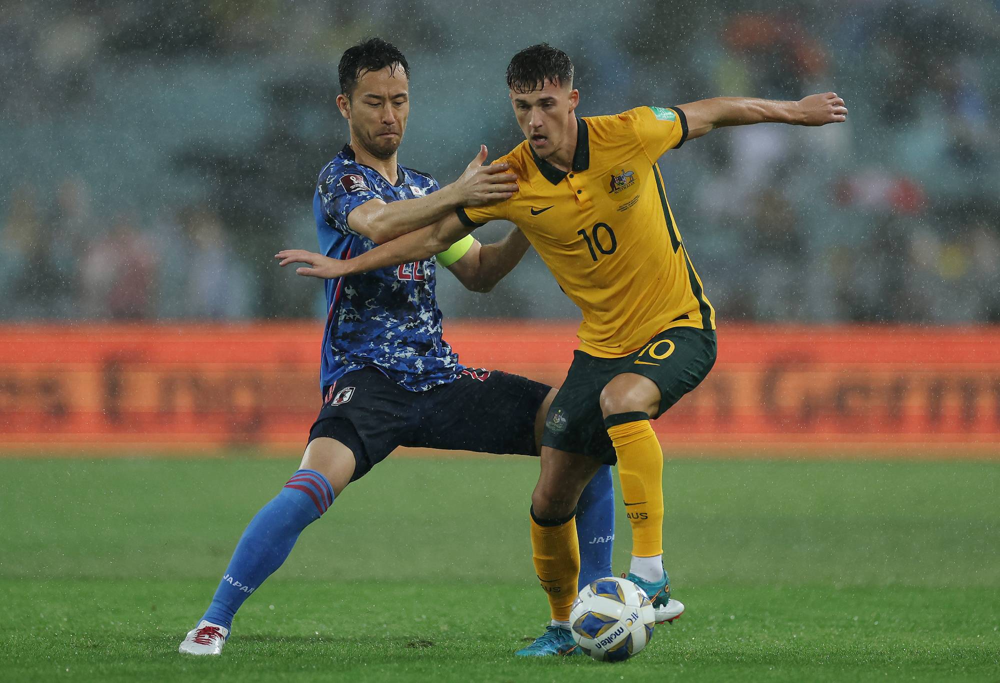 Maya Yoshida of Japan and Ajdin Hrustic of the Socceroos compete for the ball during the FIFA World Cup Qatar 2022 AFC Asian Qualifying match between the Australia Socceroos and Japan at Accor Stadium on March 24, 2022 in Sydney, Australia. (Photo by Cameron Spencer/Getty Images)