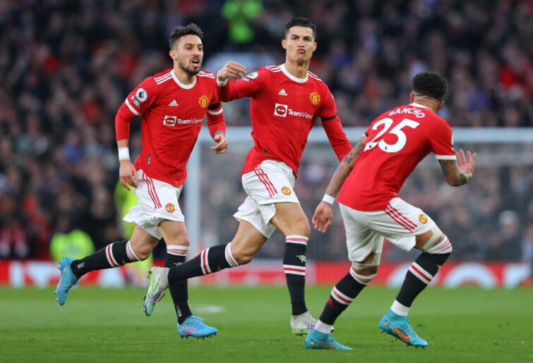 Cristiano Ronaldo of Manchester United celebrates after scoring the opening goal during the Premier League match between Manchester United and Tottenham Hotspur at Old Trafford on March 12, 2022 in Manchester, England. (Photo by James Gill - Danehouse/Getty Images)