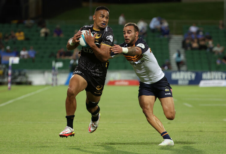 Toni Pulu of the Force runs the ball against Andy Muirhead of the Brumbies.