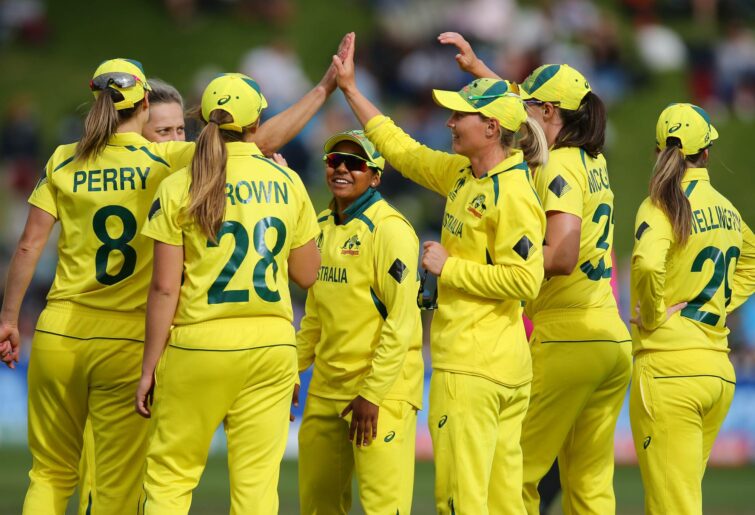 : Meg Lanning (3R) of Australia celebrates with teammates after catching out Amy Satterthwaite of New Zealand during the 2022 ICC Women's Cricket World Cup match between New Zealand and Australia at Basin Reserve on March 13, 2022 in Wellington, New Zealand. (Photo by Hagen Hopkins-ICC/ICC via Getty Images)