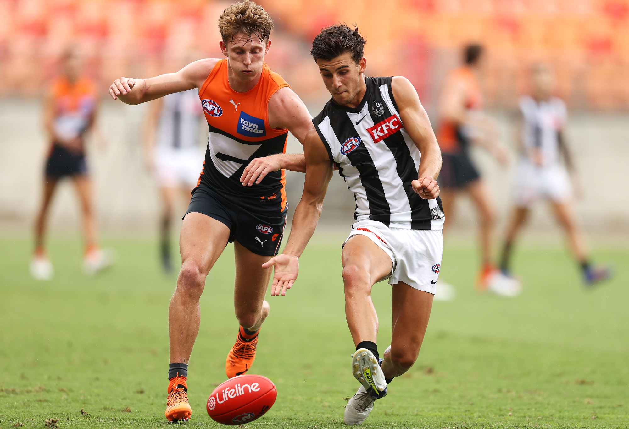 Nick Daicos competes with Lachie Whitfield.