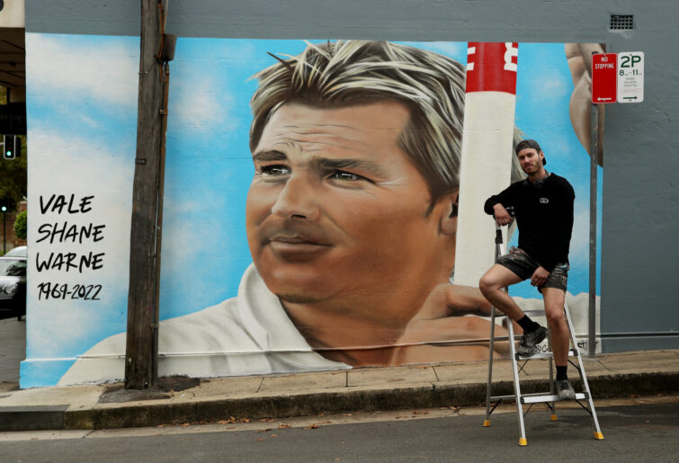 Artist Callum Hotham poses in front of his mural of Shane Warne. (Photo by Don Arnold/WireImage)
