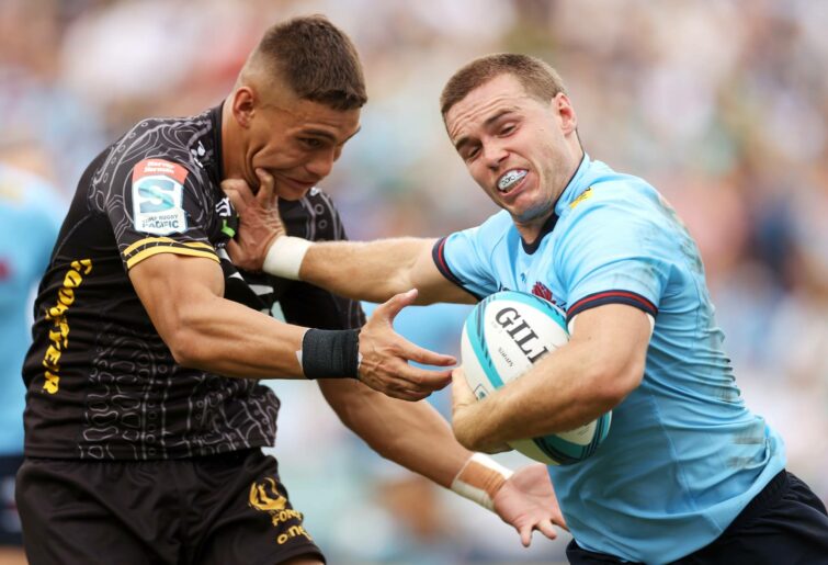 Will Harrison of the Waratahs fends off Reesjan Pasitoa of the Force during the round four Super Rugby Pacific match between the NSW Waratahs and the Western Force at Leichhardt Oval on March 13, 2022 in Sydney, Australia. (Photo by Mark Kolbe/Getty Images)