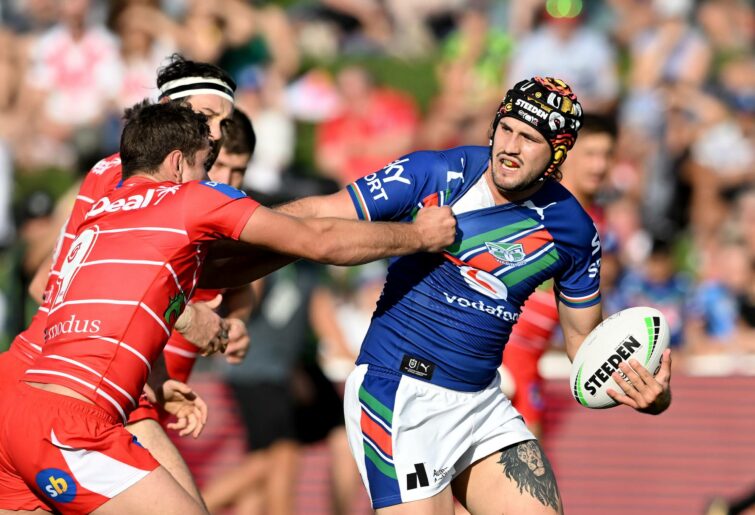 SUNSHINE COAST, AUSTRALIA - MARCH 12: Josh Curran of the Warriors attempts to break away from the defence of Andrew McCullough of the Dragons during the round one NRL match between the New Zealand Warriors and the St George Illawarra Dragons at Sunshine Coast Stadium, on March 12, 2022, in Sunshine Coast, Australia. (Photo by Bradley Kanaris/Getty Images)