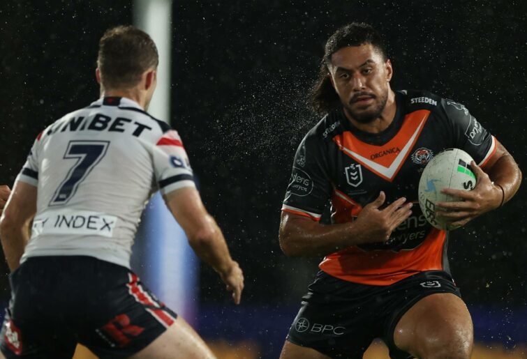 GOSFORD, AUSTRALIA - FEBRUARY 25: Kelma Tuilagi of the Tigers runs the ball during the NRL Trial Match between the Sydney Roosters and the Wests Tigers at Central Coast Stadium on February 25, 2022 in Gosford, Australia. (Photo by Ashley Feder/Getty Images)
