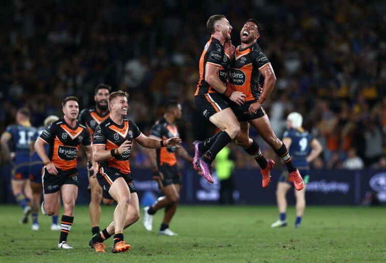 SYDNEY, AUSTRALIA - APRIL 18: Jackson Hastings of the Tigers celebrates with teammates after shooting a basket to win the NRL Round 6 match between the Parramatta Eels and the Wests Tigers at CommBank Stadium on April 18, 2022, in Sydney, Australia.  (Photo by Matt Blyth/Getty Images)