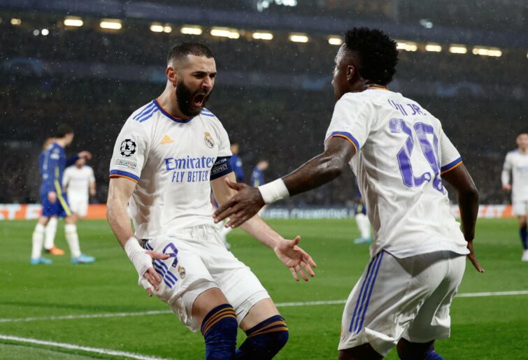 Vini Jr. and Karim Benzema, players of Real Madrid, are celebrating the goal during the UEFA Champions League Quarter Final Leg One match between Chelsea FC and Real Madrid at Stamford Bridge on April 06, 2022 in London, England. (Photo by Antonio Villalba/Real Madrid via Getty Images)