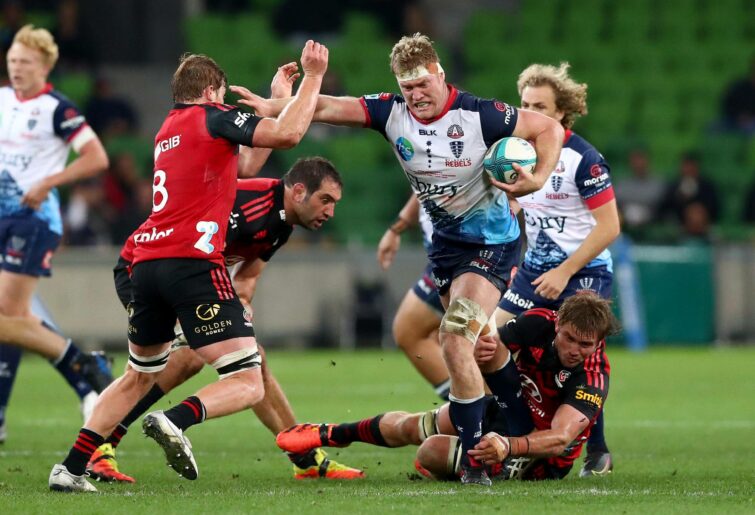 Matt Philip of the Rebels runs with the ball while being tackled during the round 10 Super Rugby Pacific match between the Crusaders and the Melbourne Rebels at AAMI Park on April 24, 2022 in Melbourne, Australia. (Photo by Kelly Defina/Getty Images)