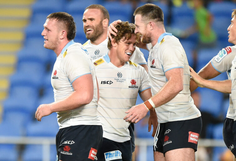 Michael Hooper of the Waratahs celebrates scoring a try with teammates.