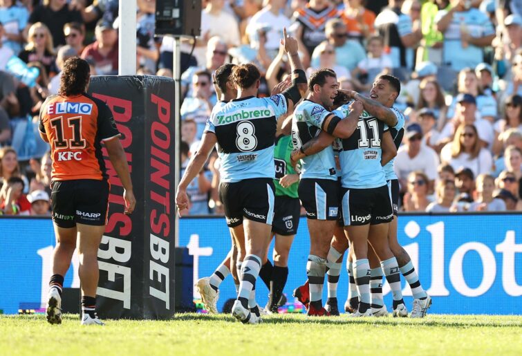 NRL Rd 5 - Sharks v Wests Tigers SYDNEY, AUSTRALIA - April 10: Sharks' Englishman Nikora faces teammates after scoring a try during the Round 5 NRL match between Cronulla Sharks and Wests Tigers in a point bet and celebrate at the Stadium, 10 April 2022, Sydney, Australia.  (Photo by Mark Kolbe/Getty Images)