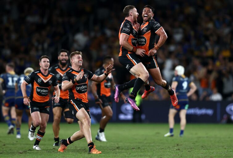 Jackson Hastings of the Tigers celebrates with team mates after kicking a field-goal to win the round six NRL match between the Parramatta Eels and the Wests Tigers at CommBank Stadium on April 18, 2022, in Sydney, Australia. (Photo by Matt Blyth/Getty Images)
