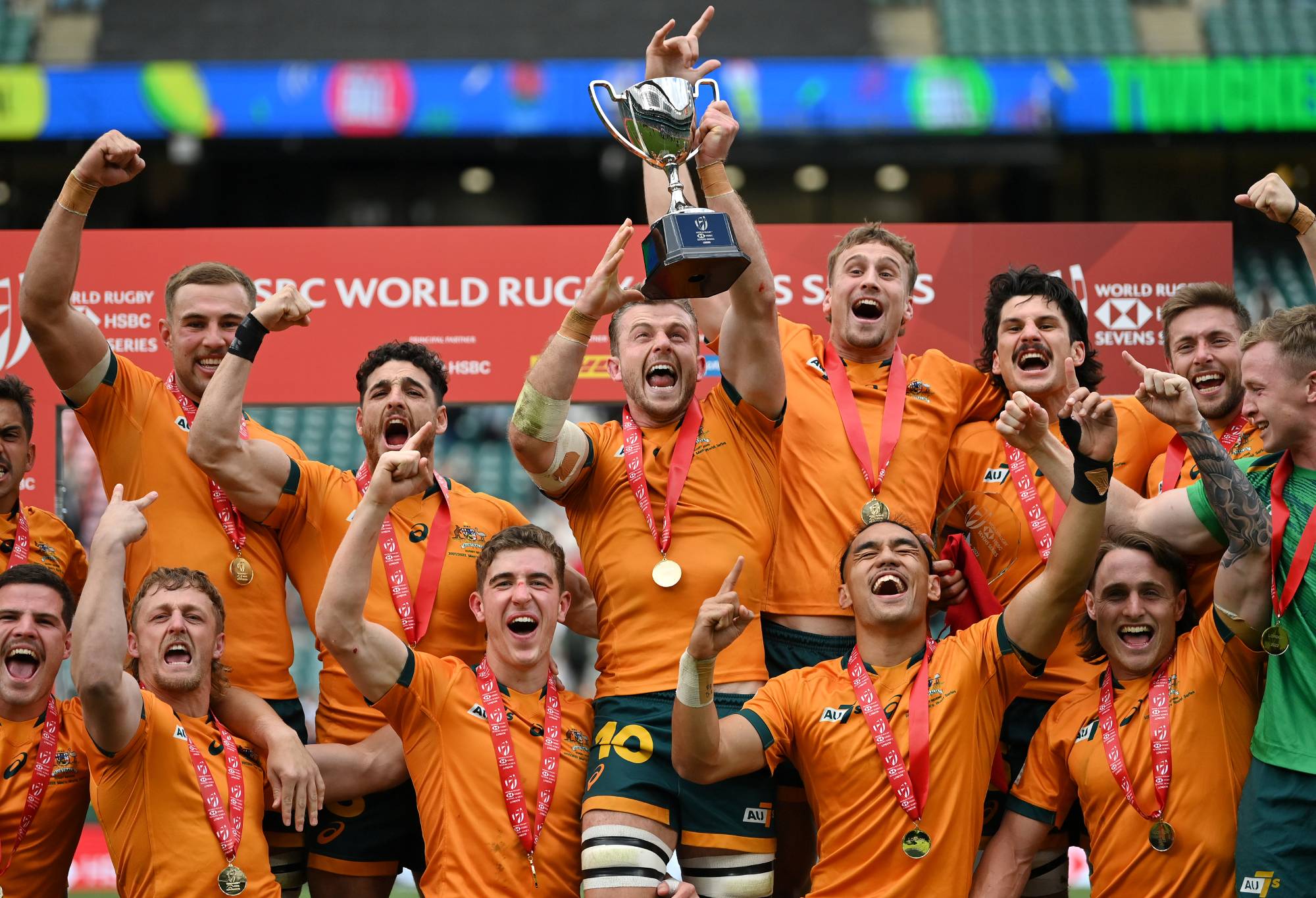 Nick Malouf of Australia (c) lifts the trophy and celebrates with his team mates after the Final between New Zealand and Australia on day two of the HSBC London Sevens at Twickenham Stadium on May 29, 2022 in London, England. (Photo by Dan Mullan - RFU/The RFU Collection via Getty Images)