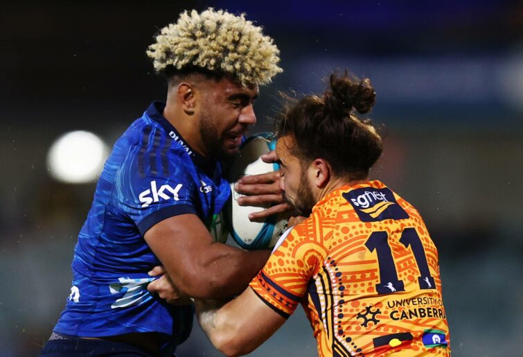 Hoskins Sotutu of the Blues is tackled during the round 14 Super Rugby Pacific match between the ACT Brumbies and the Blues at GIO Stadium on May 21, 2022 in Canberra, Australia. (Photo by Mark Nolan/Getty Images)