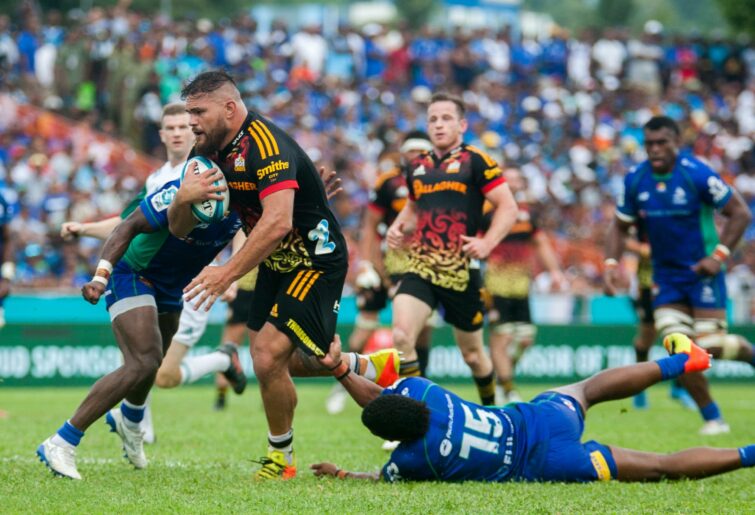 Angus Taavao of the Chiefs runs against a tackle during the round 15 Super Rugby Pacific match between the Fijian Drua and the Chiefs at Churchill Park on May 28, 2022 in Lautoka, Fiji. (Photo by Pita Simpson/Getty Images)