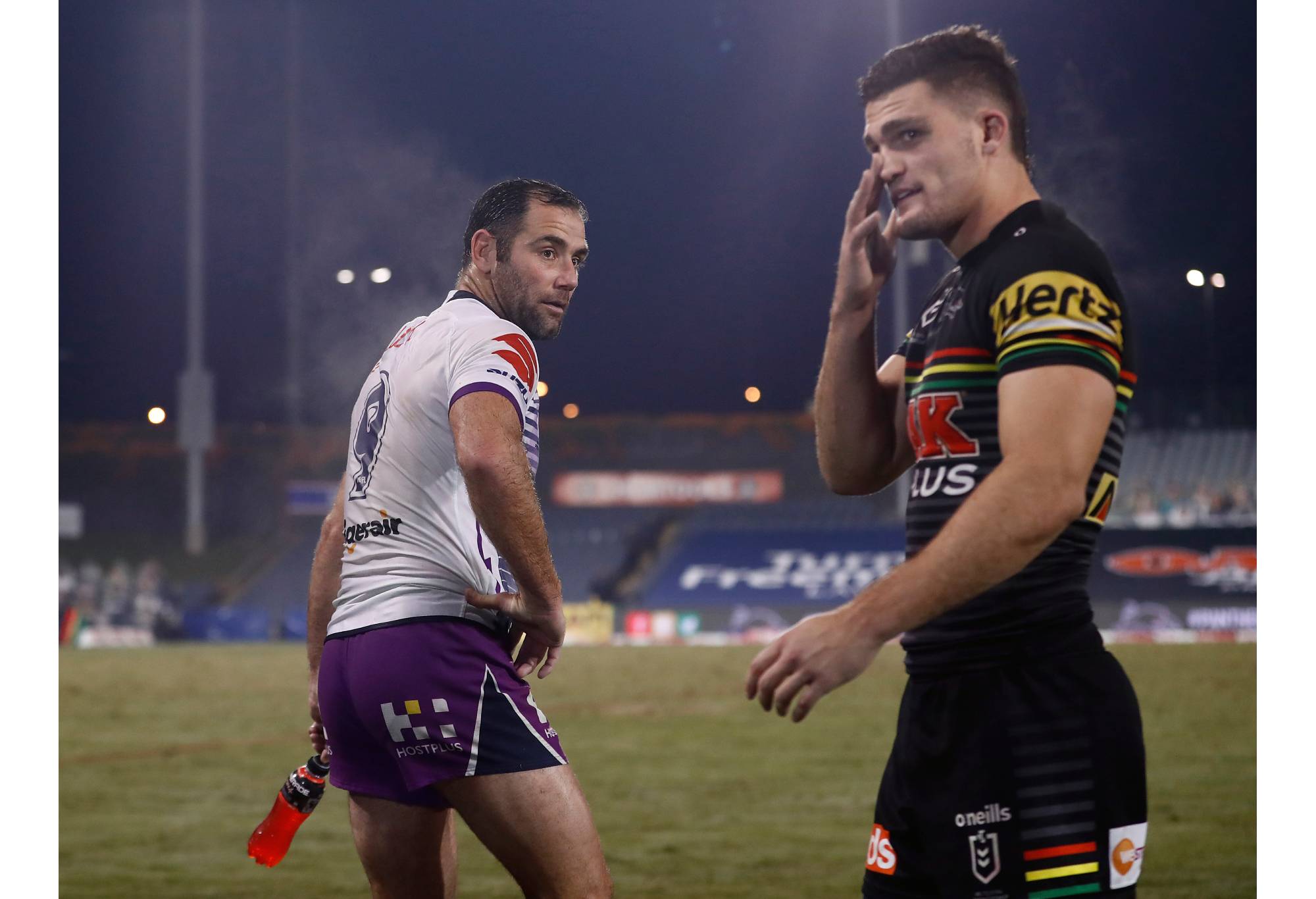 SYDNEY, AUSTRALIA - JUNE 19: Cameron Smith of the Storm passes Nathan Cleary of the Panthers after the round six NRL match between the Penrith Panthers and the Melbourne Storm at Campbelltown Stadium on June 19, 2020 in Sydney, Australia. (Photo by Ryan Pierse/Getty Images)
