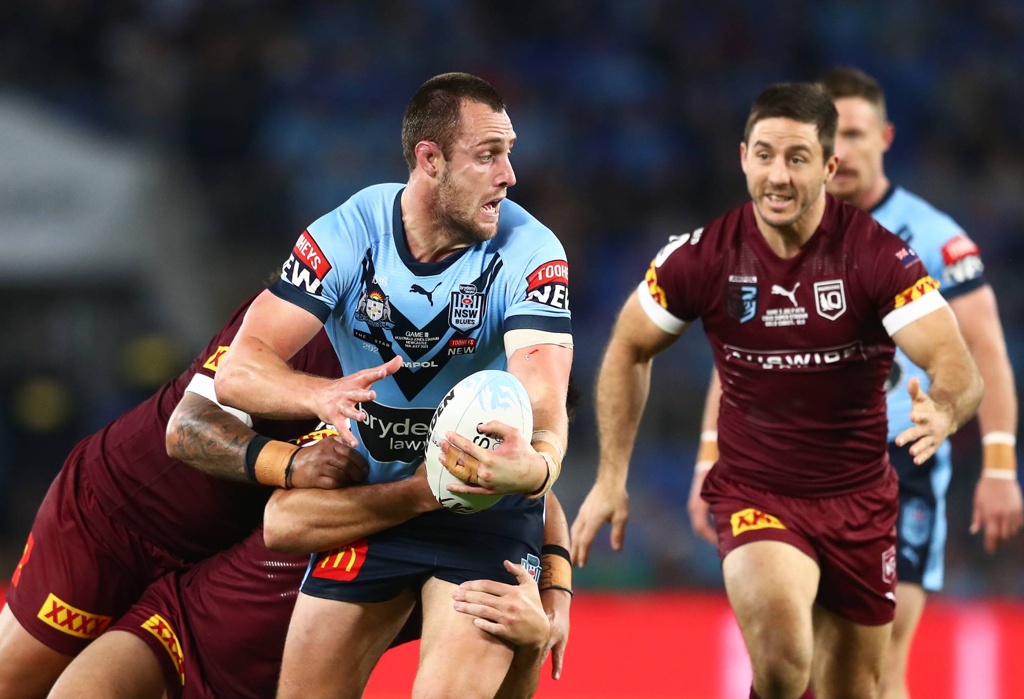 GOLD COAST, AUSTRALIA - JULY 14: Isaah Yeo of the Blues is tackled during game three of the 2021 State of Origin Series between the New South Wales Blues and the Queensland Maroons at Cbus Super Stadium on July 14, 2021 in Gold Coast, Australia. (Photo by Chris Hyde/Getty Images)