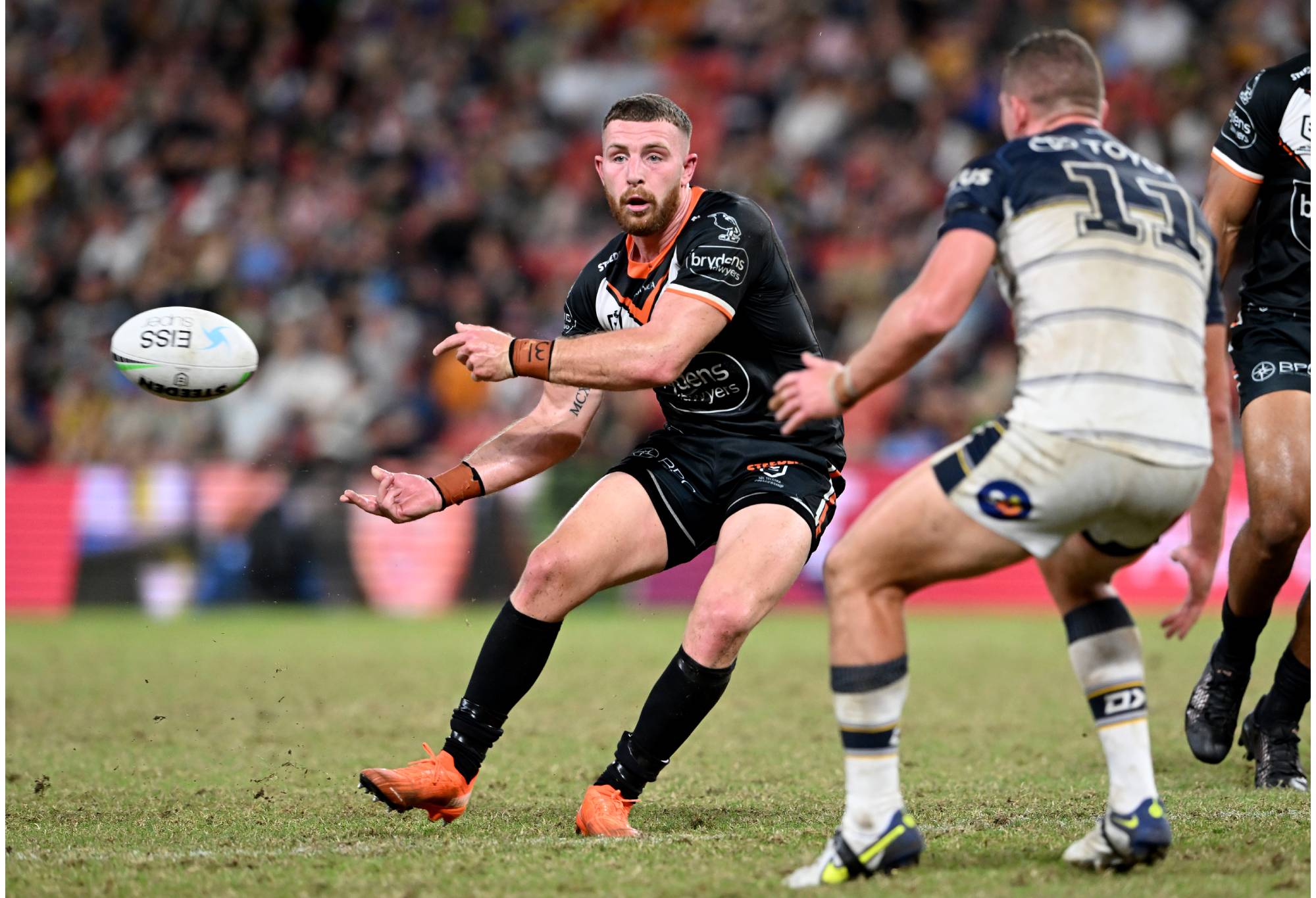 BRISBANE, AUSTRALIA - MAY 15: Jackson Hastings of the Tigers passes the ball during the round 10 NRL match between the Wests Tigers and the North Queensland Cowboys at Suncorp Stadium, on May 15, 2022, in Brisbane, Australia. (Photo by Bradley Kanaris/Getty Images)