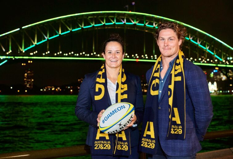 Michael Hooper (R) and Shannon Parry (L) pose for a photo in front of The Sydney Harbour Bridge, lit in support of Rugby Australia's 2027 & 2029 Rugby World Cup Bids, on May 12, 2022 in Sydney, Australia. (Photo by Brett Hemmings/Getty Images for Rugby Australia)