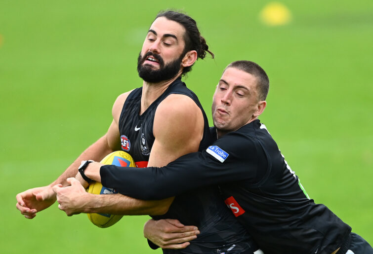 Brodie Grundy is approached by Darcy Cameron.