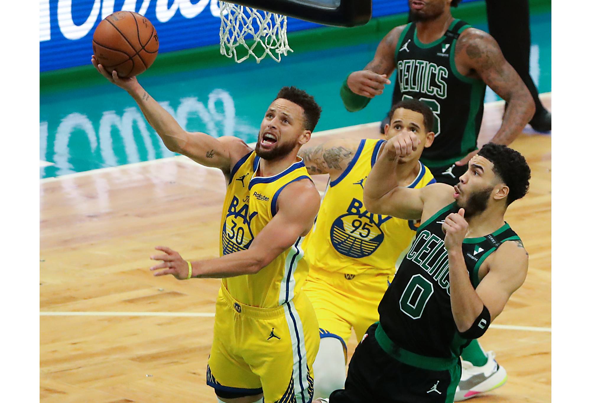 Boston, MA - April 17: Golden State Warriors guard Stephen Curry (30) makes a layup beating Boston Celtics forward Jayson Tatum (0) during third quarter of the NBA action at TD Garden in Boston on April 17, 2021. (Photo by Matthew J. Lee/The Boston Globe via Getty Images)