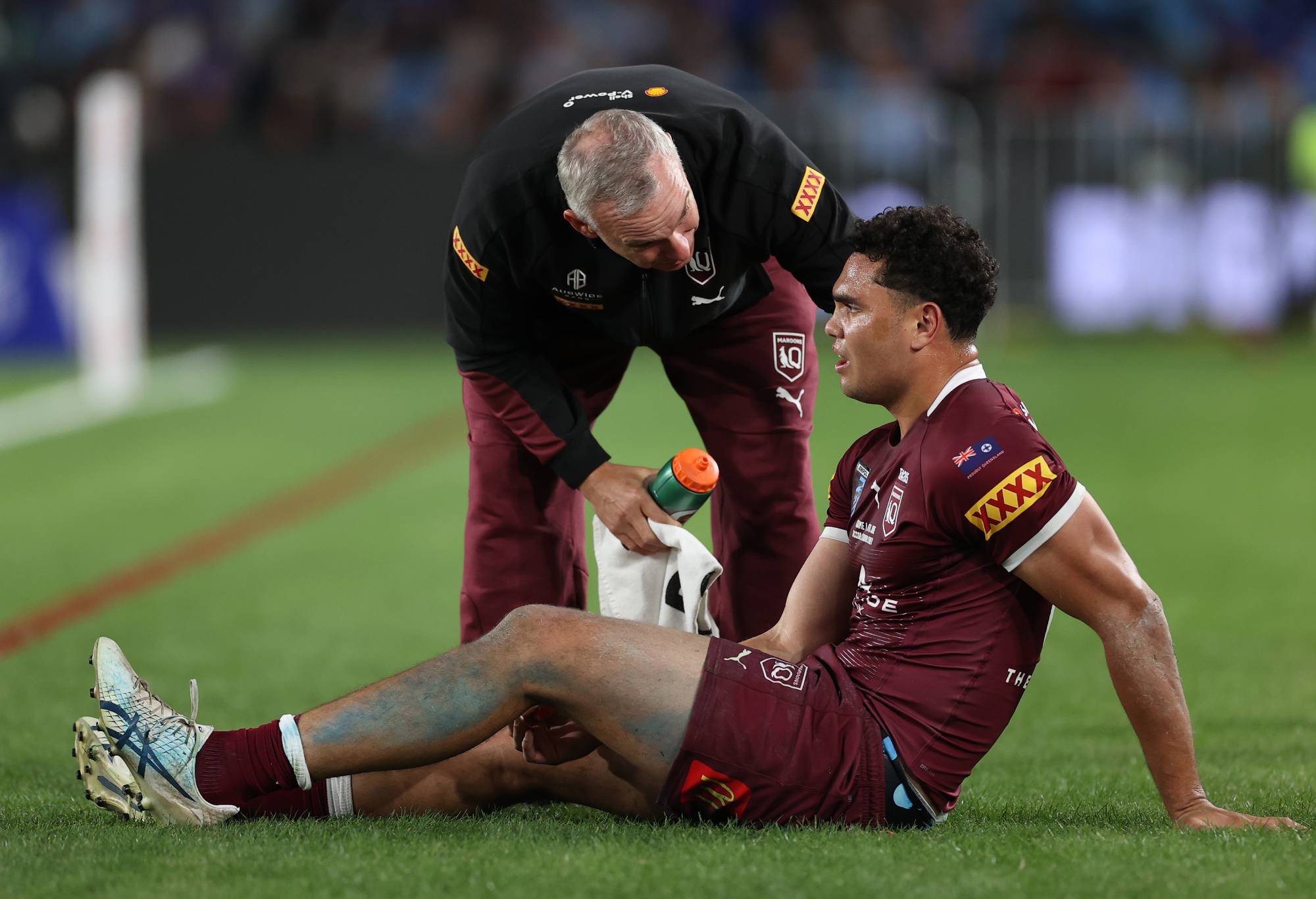 SYDNEY, AUSTRALIA - JUNE 08: Xavier Coates of the Maroons receives attention after sustaining an injury during game one of the 2022 State of Origin series between the New South Wales Blues and the Queensland Maroons at Accor Stadium on June 08, 2022 in Sydney, Australia. (Photo by Cameron Spencer/Getty Images)