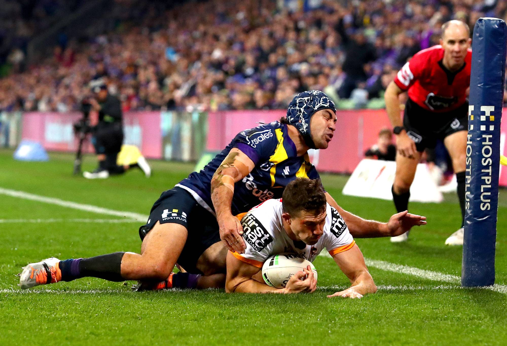 MELBOURNE, AUSTRALIA - JUNE 17: Corey Oates of the Broncos scores a try under pressure from Jahrome Hughes of the Storm during the round 15 NRL match between the Melbourne Storm and the Brisbane Broncos at AAMI Park, on June 17, 2022, in Melbourne, Australia. (Photo by Kelly Defina/Getty Images)