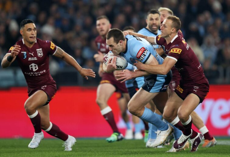 Isaah Yeo of the Blues is tackled during the 2022 State of Origin Series opener between the New South Wales Blues and the Queensland Maroons at Accor Stadium on June 08, 2022 in Sydney, Australia.  (Photo by Mark Kolbe/Getty Images)
