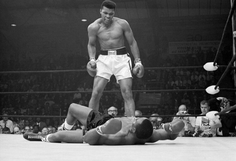 Heavyweight champion Muhammad Ali stands over Sonny Liston and taunts him to get up during their title fight. Ali knocked Liston out in one minute in the first round during their bout at the Central Maine Youth Center in Lewiston, Maine. Image: Getty