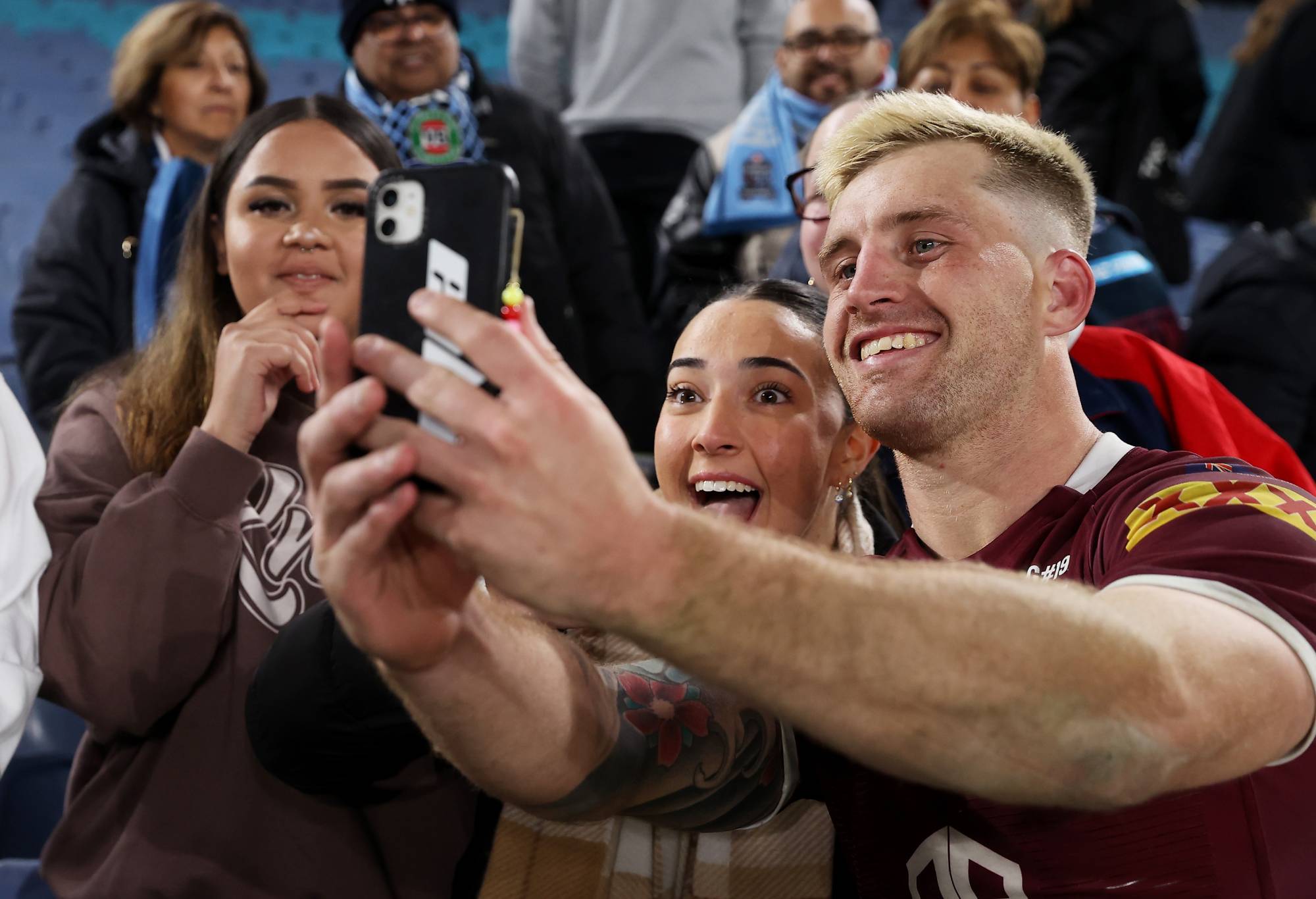 Cameron Munster of the Maroons takes a selfie with fans after game one of the 2022 State of Origin series between the New South Wales Blues and the Queensland Maroons at Accor Stadium on June 08, 2022, in Sydney, Australia. (Photo by Mark Kolbe/Getty Images)