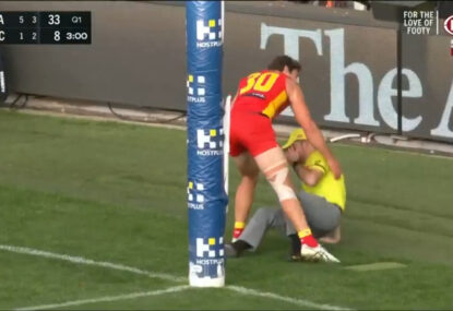 Boundary umpire needed to make a call on a missed goal after his colleague takes a tumble