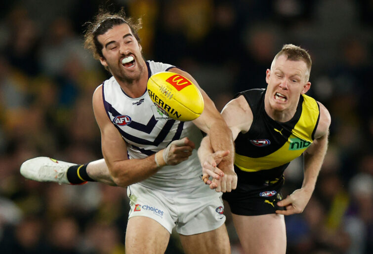 Alex Pearce of the Dockers and Jack Riewoldt of the Tigers compete for the ball.