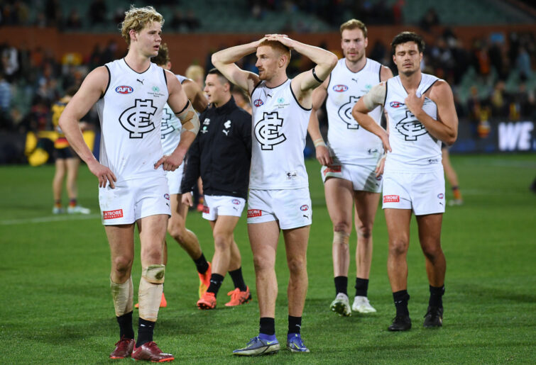 Carlton players head off the ground.